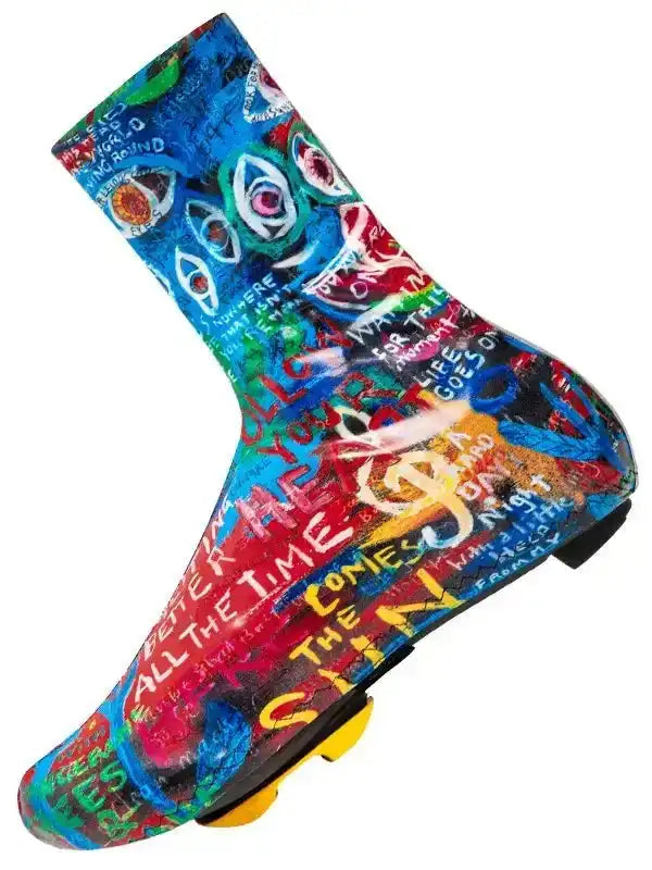 Colorful graffiti-style cycling shoe cover with bold text and eye designs for road biking