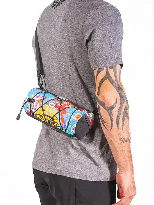 Colorful cycling waist bag with vibrant pattern worn by man in gray tee