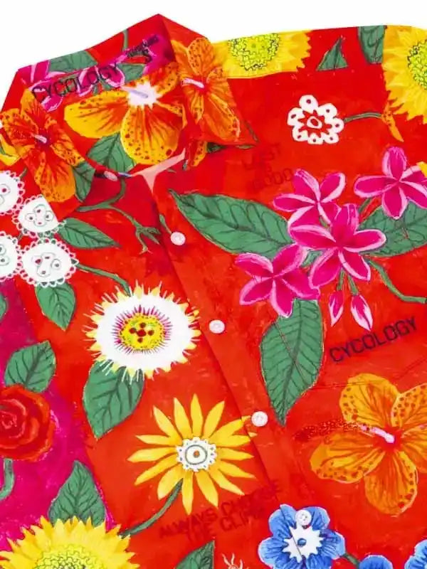 Vibrant red cycling shirt with tropical floral print, featuring hibiscus and sunflowers on high-quality fabric.