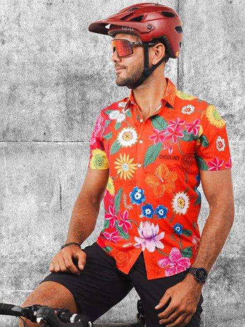 Man in vibrant floral cycling jersey and red helmet, ready for a ride