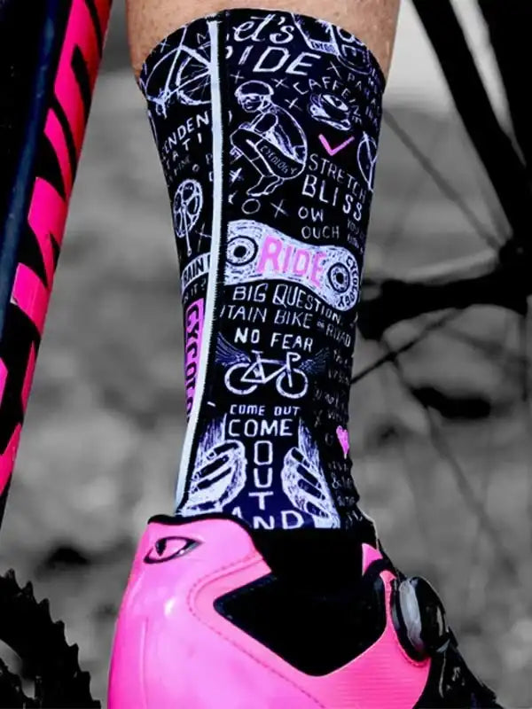Cycling socks with bold graphic print, pink cycling shoe, and bike frame detail