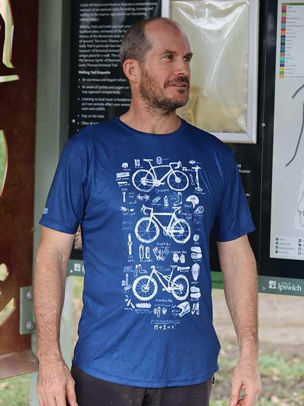 Man wearing blue cycling t-shirt with bike diagram print, ideal for road or mountain biking adventures.