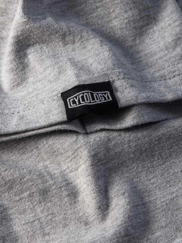 Cycology brand tag on gray cycling apparel fabric, showcasing quality design for men's and women's wear