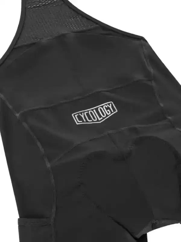 Black cycling bib shorts with Cycology logo, padded seat, and mesh back panel for breathability