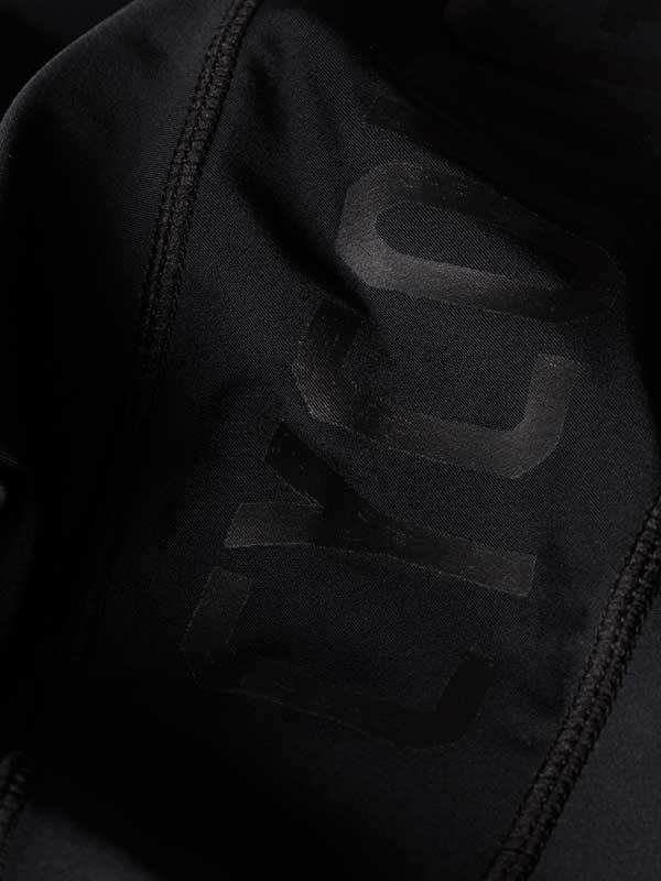 Black cycling jersey with subtle logo detail, high-quality fabric for performance wear