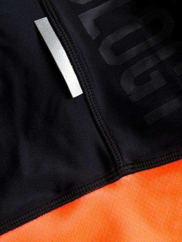 Black and orange cycling jersey with reflective strip and subtle logo detail