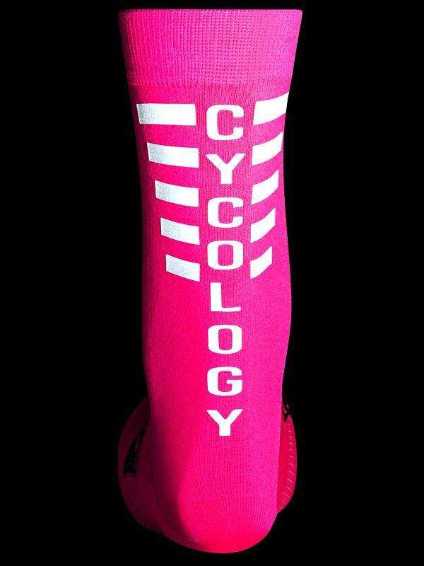 Bright pink cycling sock with white CYCOLOGY text and reflective stripes, designed for performance and visibility.