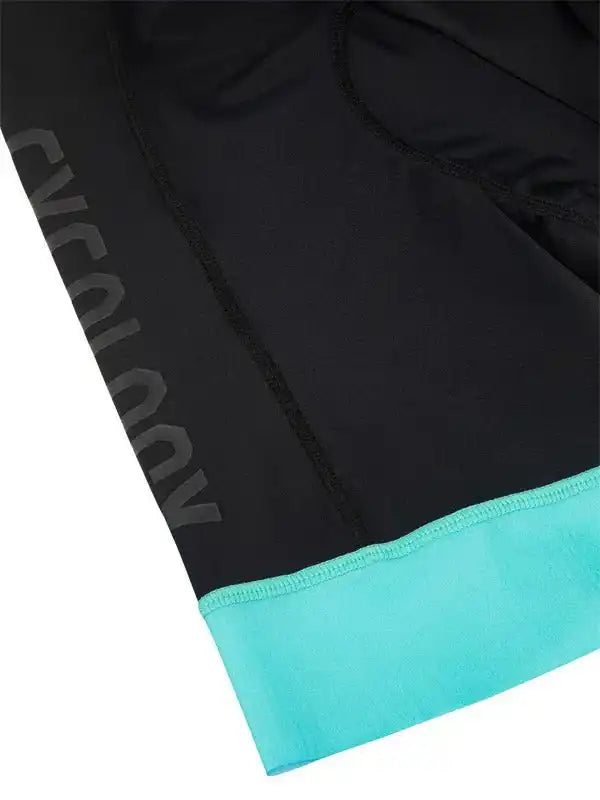 Black cycling shorts with turquoise hem and subtle side branding, designed for comfort and performance.