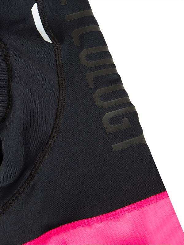 Black cycling shorts with pink hem and subtle brand lettering, designed for performance and comfort.