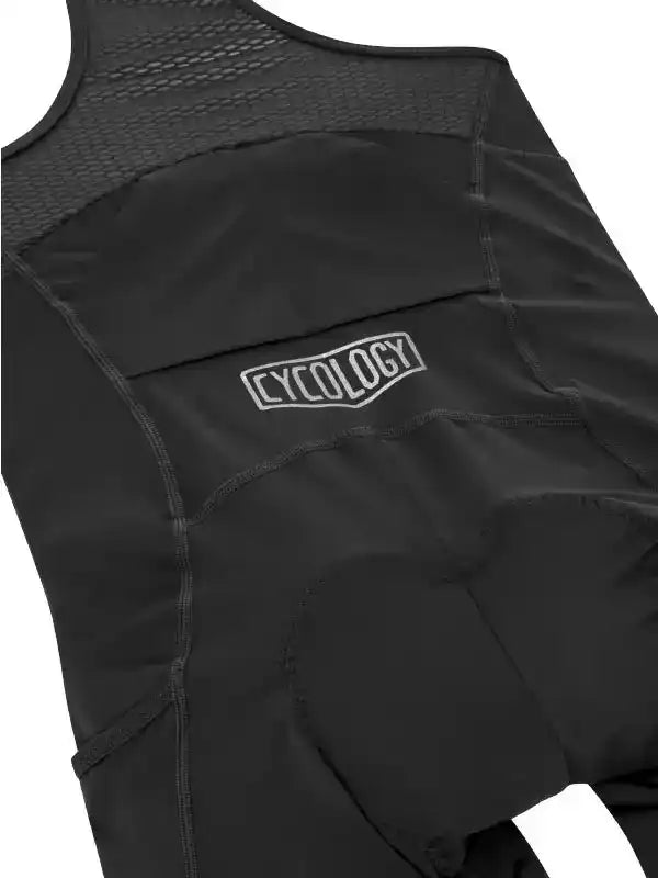 Black cycling bib shorts with padded seat and mesh back, featuring Cycology logo for men's and women's rides.