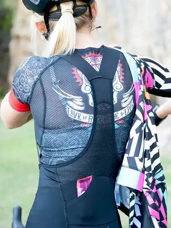 Woman wearing cycling jersey with 'Live to Ride' graphic, mesh back, and colorful design