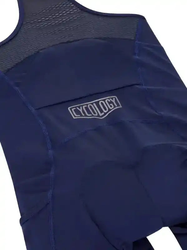 Navy blue cycling bib shorts with mesh back panel and Cycology logo, designed for comfort and performance.
