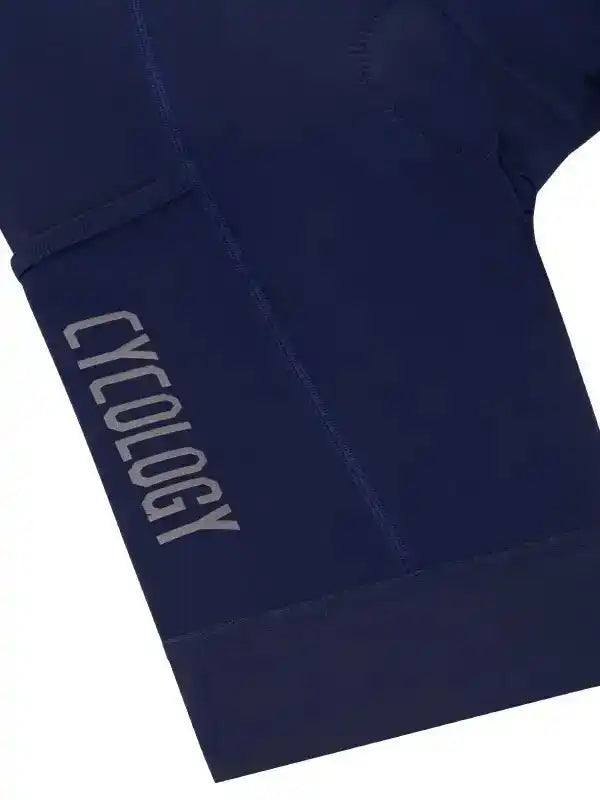Navy blue cycling shorts with 'CYCOLOGY' logo, high-quality fabric for men's and women's bike wear