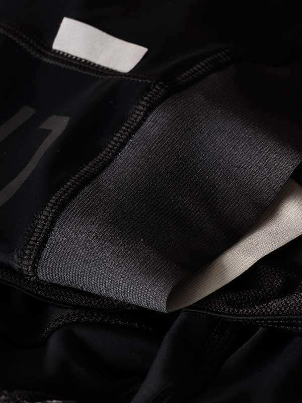 Close-up of black cycling shorts with elastic waistband and inner lining, showcasing high-quality fabric details.