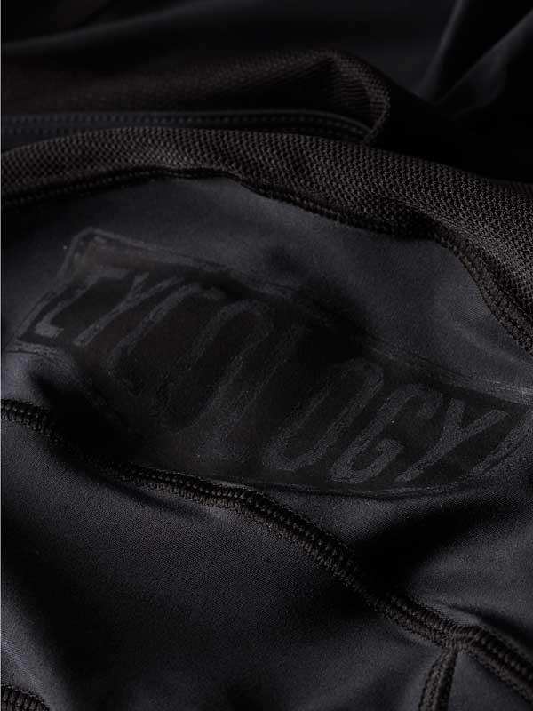 Black cycling jersey with subtle brand logo, high-quality fabric detail