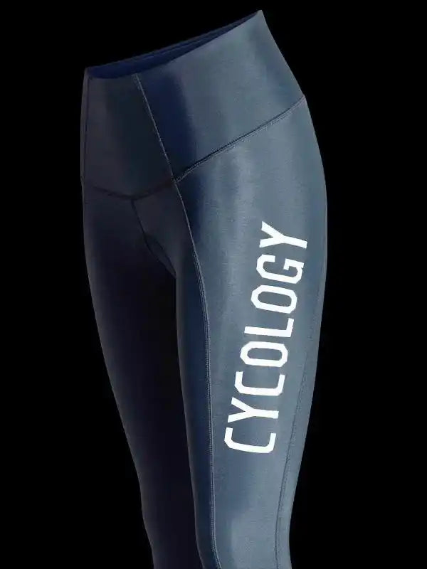 Dark blue women's cycling tights with white CYCOLOGY logo, high-waisted design for performance rides