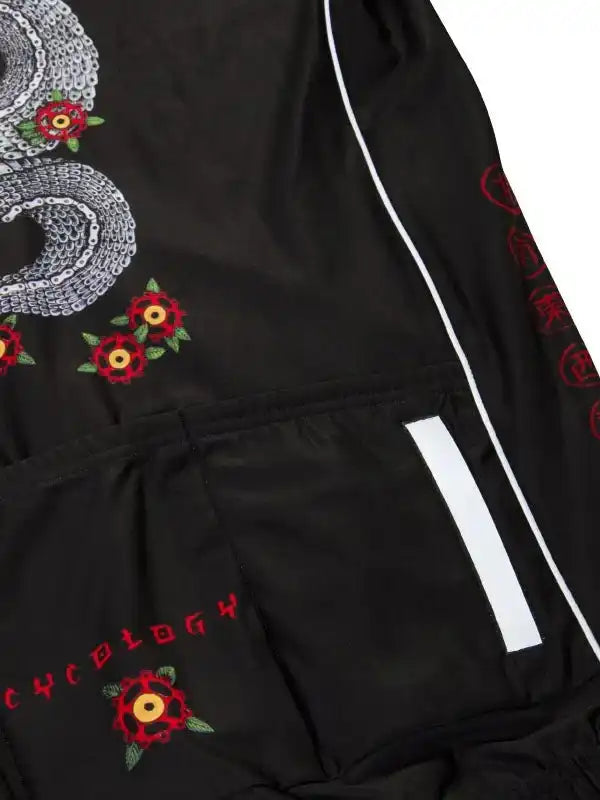 Black cycling shorts with red floral embroidery, chain design, and reflective stripe for visibility