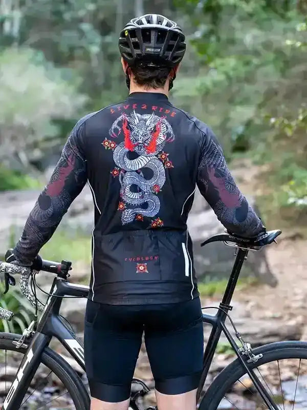 Men's cycling jersey with dragon graphic, long sleeves, black bike shorts, forest trail ride