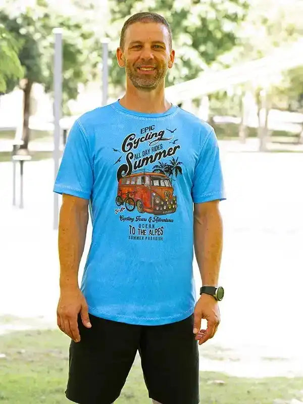 Man wearing blue cycling t-shirt with vintage van graphic, summer adventure design, ideal for bike rides