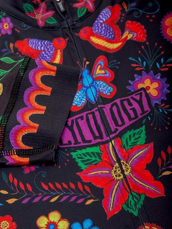 Vibrant floral and bird pattern on black cycling jersey with colorful embroidery details