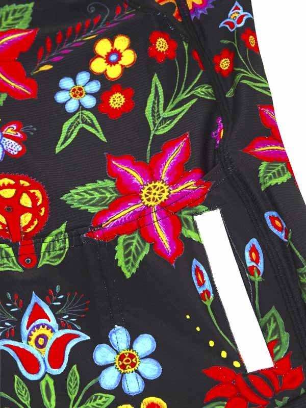 Vibrant floral print cycling shorts with colorful flowers and green leaves on black fabric