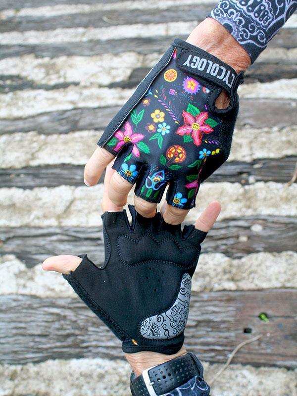 Colorful floral cycling gloves with black base, fingerless design, and brand logo on wrist