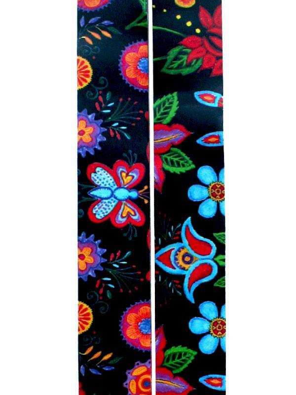 Vibrant floral and butterfly print cycling fabric in bold colors on black background