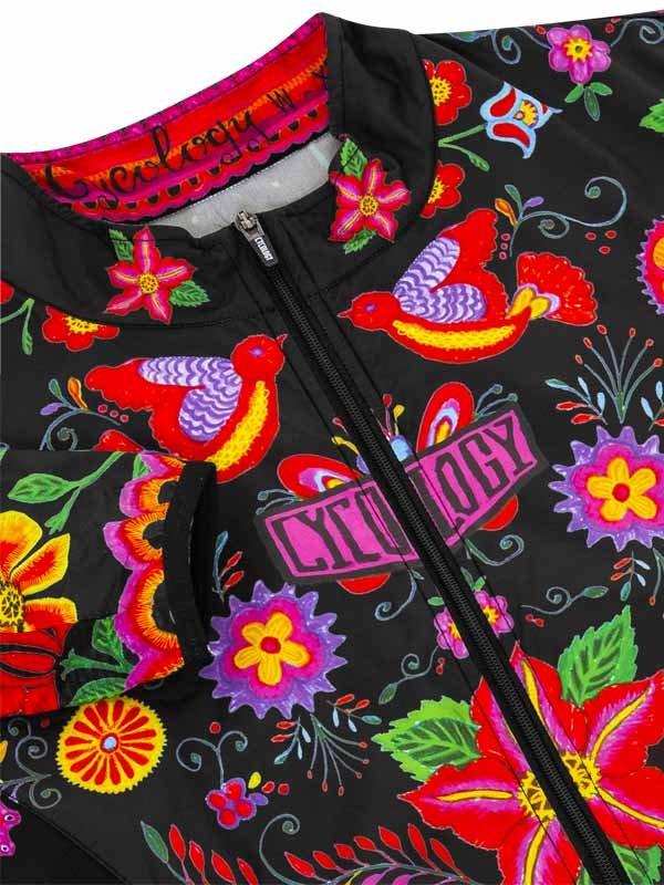 Vibrant floral and bird print cycling jacket with bold colors and zipper detail
