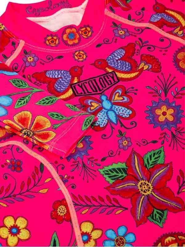 Vibrant pink cycling jersey with floral and bird print, featuring 'CYCOLOGY' logo on chest