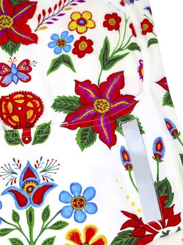 Colorful floral and butterfly print cycling shorts with vibrant red, blue, and green designs on white fabric