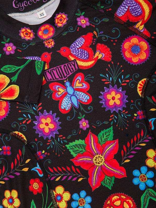 Vibrant floral and bird print cycling jersey with bold colors and intricate patterns for women and men.