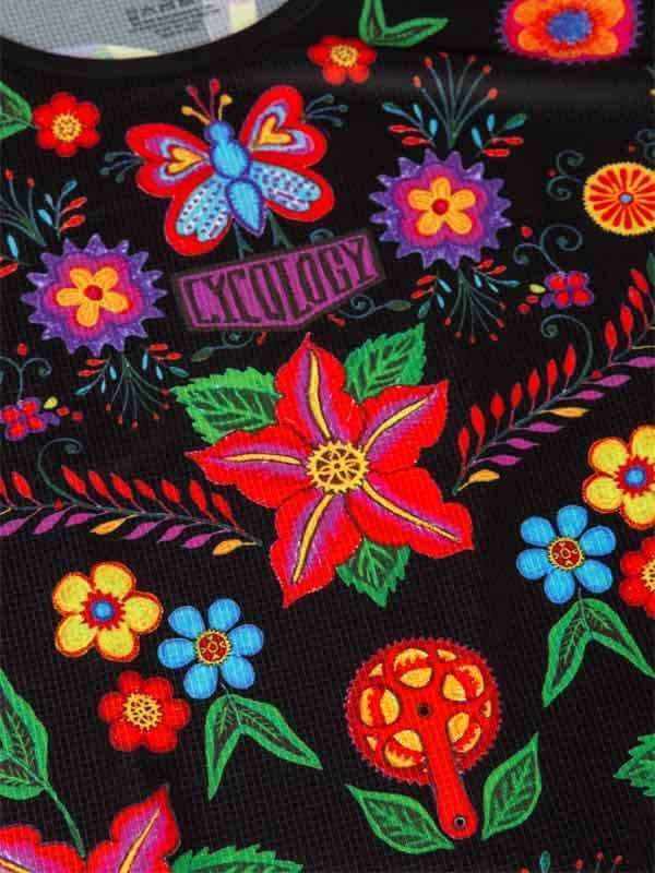 Vibrant floral and butterfly print cycling jersey with bold colors and bike gear motifs