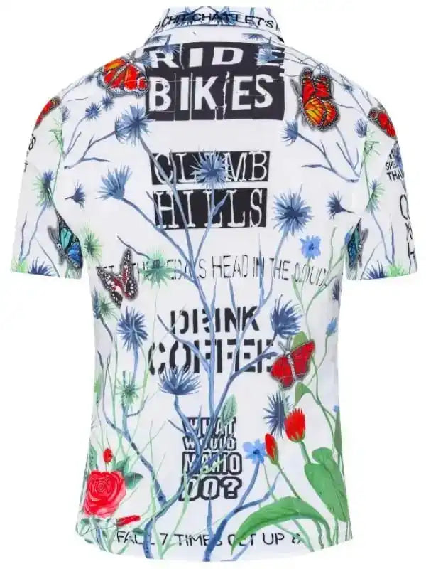 White cycling shirt with floral print, butterflies, and bold text like 'RIDE BIKES' and 'DRINK COFFEE'