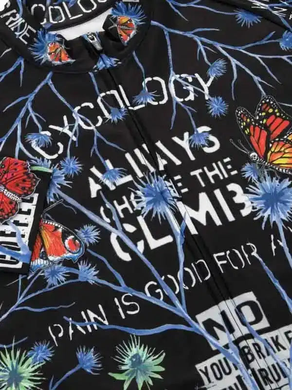 Black cycling jersey with butterfly and floral print, bold text 'Always Choose The Climb'