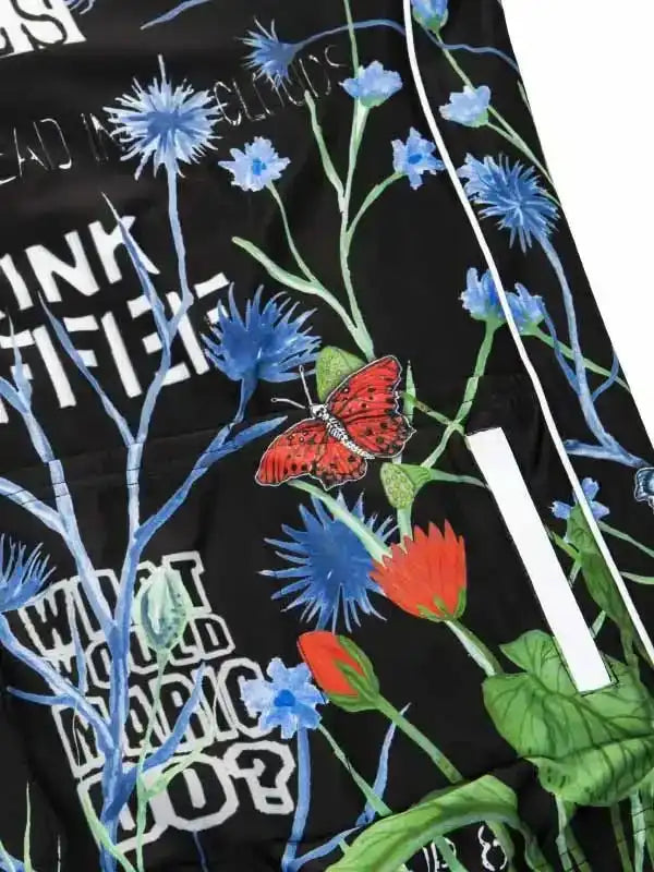 Black cycling jersey with blue flowers, red butterfly, and bold white text design