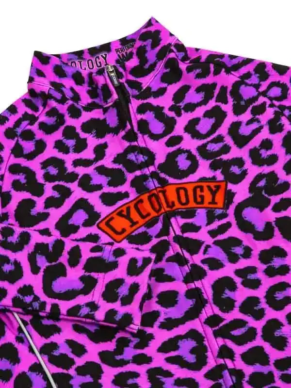 Vibrant pink and purple leopard print cycling jersey with bold 'CYCOLOGY' logo, perfect for women's cycling wear.
