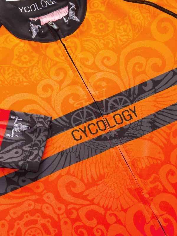 Orange and black cycling jersey with CYCOLOGY branding and intricate swirl patterns, designed for performance and style.
