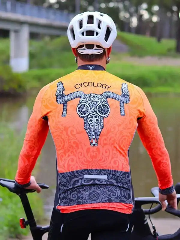 Men's cycling jersey with skull and bike wheel design, orange gradient, long sleeve, back view