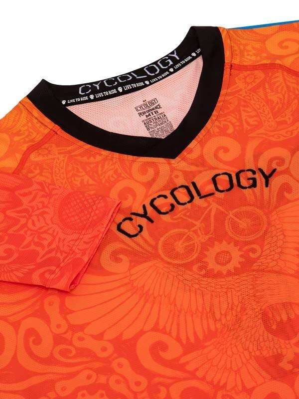 Vibrant orange cycling jersey with bold 'CYCOLOGY' print, wing and gear patterns, ideal for men's and women's rides.