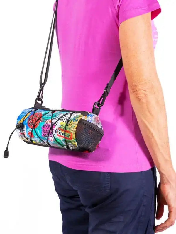 Colorful cycling waist bag with mesh pocket, worn by woman in pink shirt