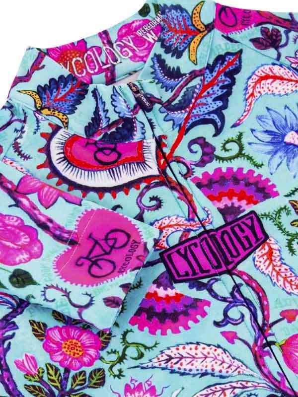 Vibrant floral and gear patterned cycling jersey with bold pink and blue designs, ideal for women's bike wear.