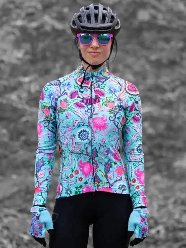Woman in colorful floral cycling jersey, helmet, and gloves for road biking