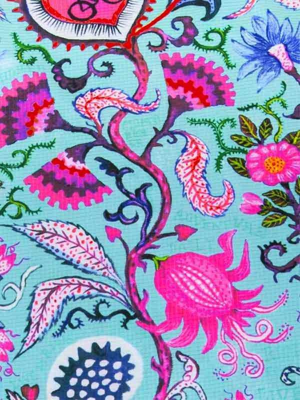 Vibrant floral cycling fabric with pink, blue, and green patterns on teal background