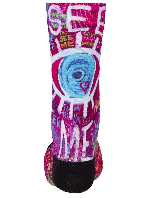 Colorful cycling sock with bold 'SEE ME' graffiti design, vibrant pink and blue art, perfect for road or mountain biking.