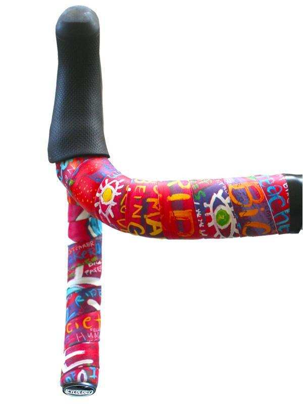 Colorful graffiti-style cycling handlebar tape with bold graphics and black grip