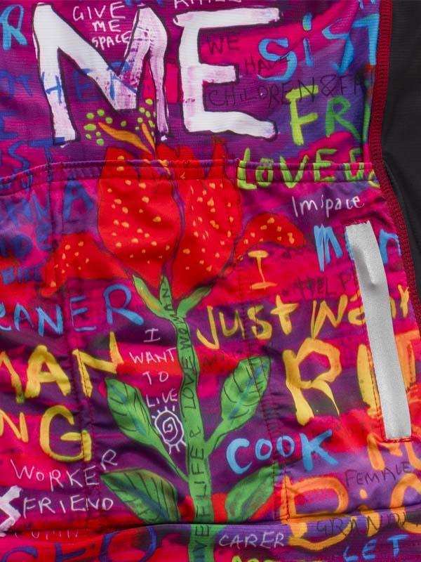 Vibrant cycling jersey with bold floral print and empowering text phrases for women riders