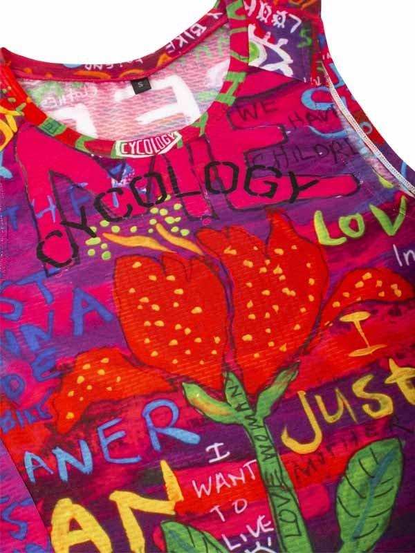 Vibrant women's cycling tank top with floral and graffiti-style art, featuring bold colors and motivational text.