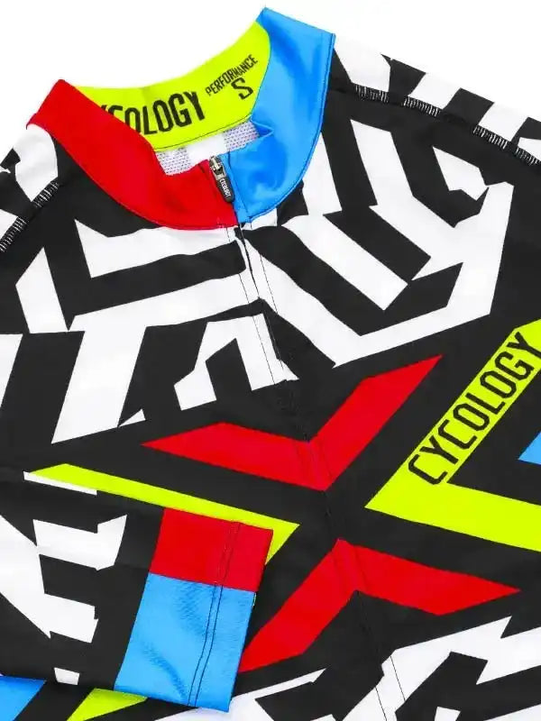Men's cycling jersey with bold black, white, red, blue, and neon yellow geometric design, performance fabric