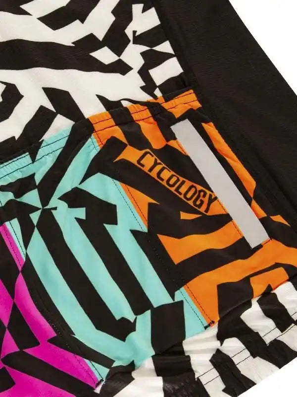 Cycology cycling shorts with bold geometric print in black, white, orange, teal, and pink