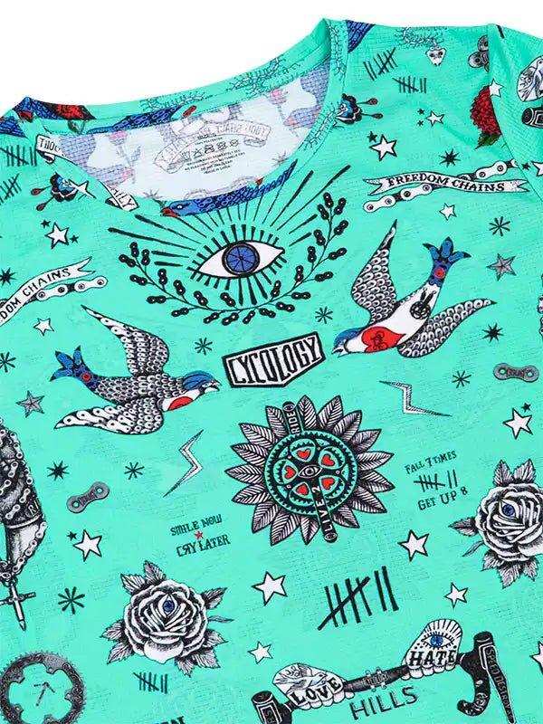 Mint green cycling jersey with tattoo-style graphics, birds, roses, and 'Cycology' text for men's and women's bike wear.